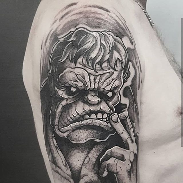 Black tattoo of Hulk, who is smoking a cigarette on right shoulder