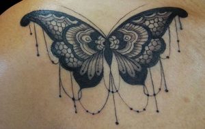 Black tattoo of butterfly on the right sholder