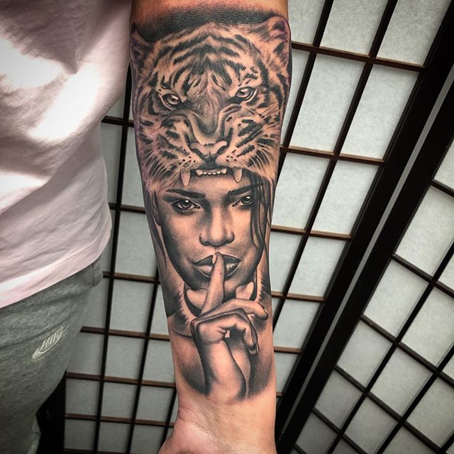 Black and Grey tattoo of an African warrior, with tiger fur on head on the left hand