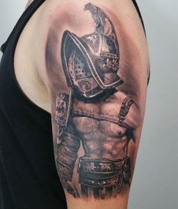 Black and Grey tattoo of a gladiator fighter on the left hand