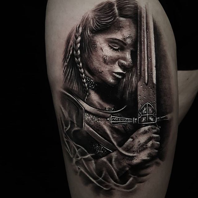 Black and Gray tattoo of female warrior with a sword on the right leg