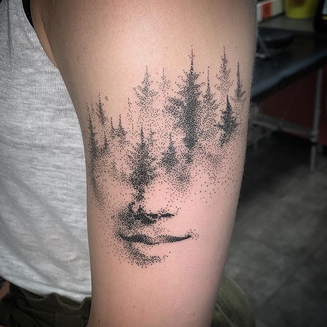 Dot work tattoo of trees and lips on the left hand