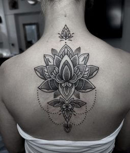 Dot work tattoo of a lotus flower on the back