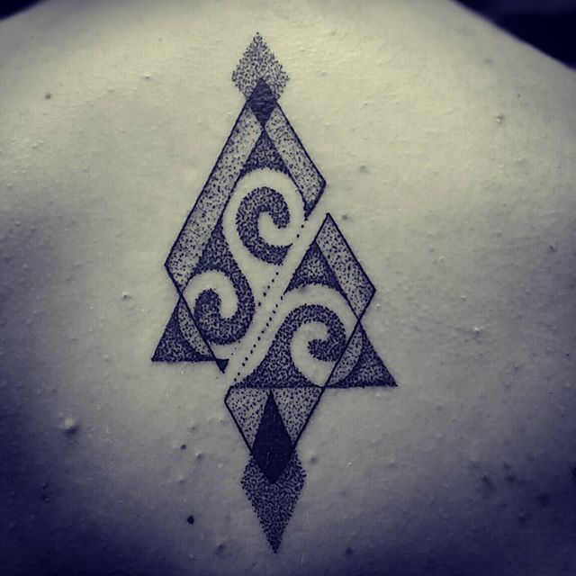 Dot work tattoo of triangles and waves on the back
