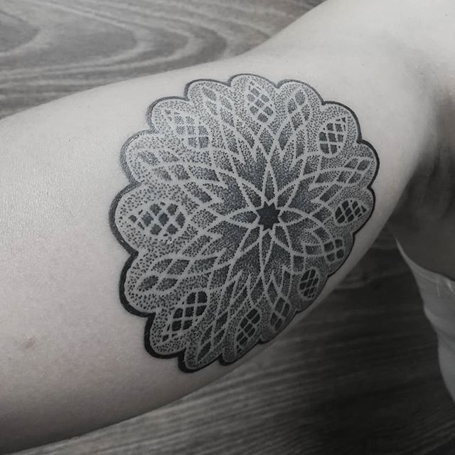 Dot work tattoo of a flower on the right hand
