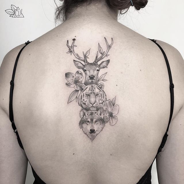 Dot work tattoo of a deer's head, a tiger's head and a wolf's head with flowers on the back