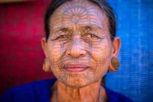 Old woman with a tattoo on the face