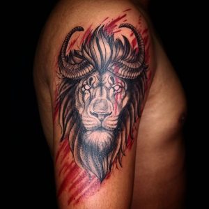 Trash polka tattoo of a lion with horns on the right shoulder