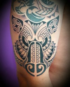 Tribal tattoo on right shoulder