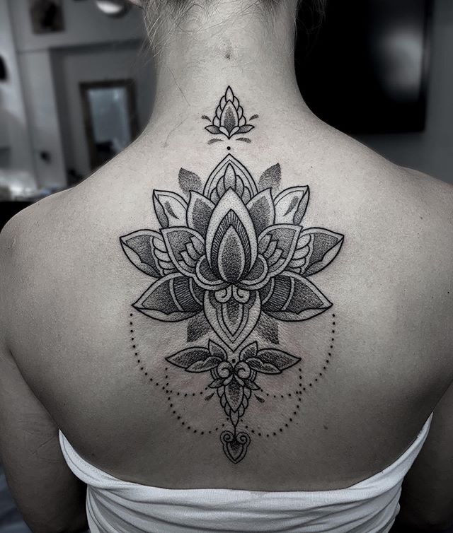 Dot work tattoo of the lotus flower on the back