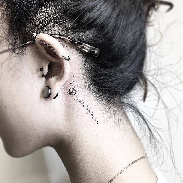 Small black tattoo on the ear