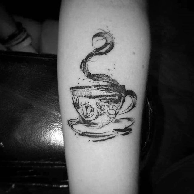 Abstract tattoo of a cup of coffee on the left hand