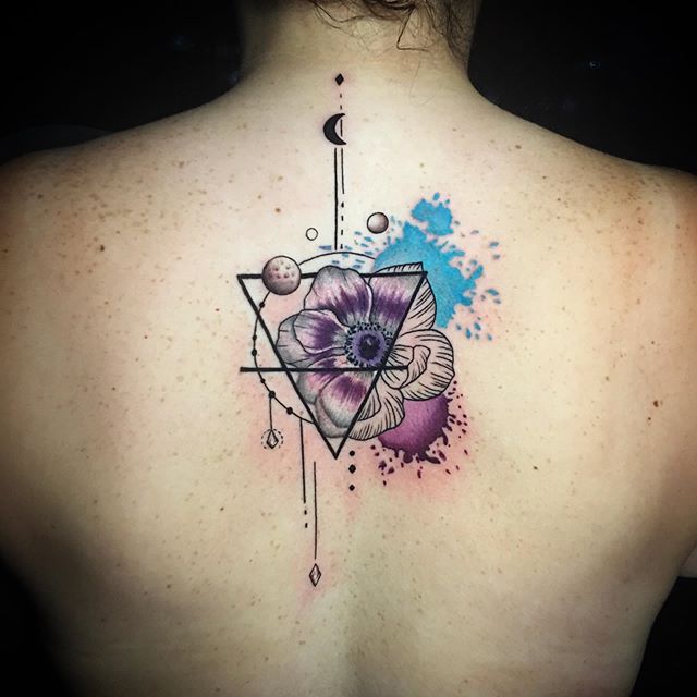Abstract color tattoo of the flower and triangle on a back
