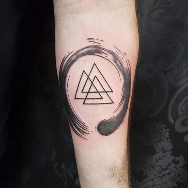 Abstract tattoo of triangles and smudge around on the left hand