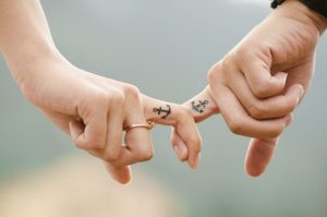 Anchor black tattoo on finger