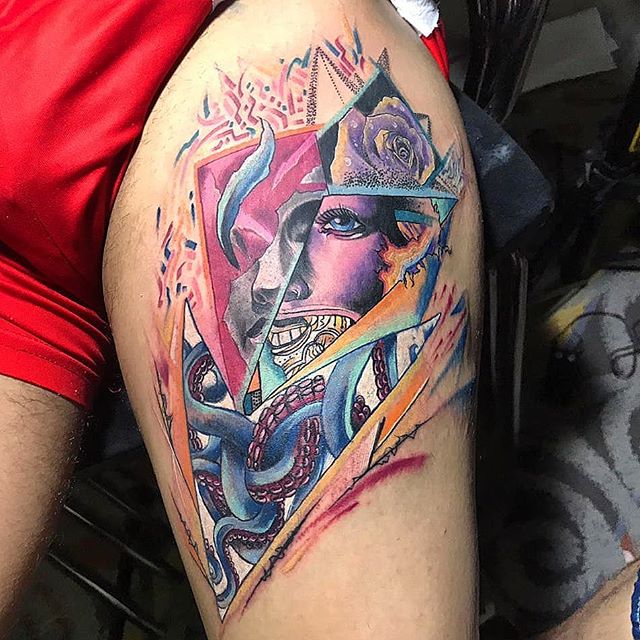 Color tattoo of a surrealistic face on the left leg
