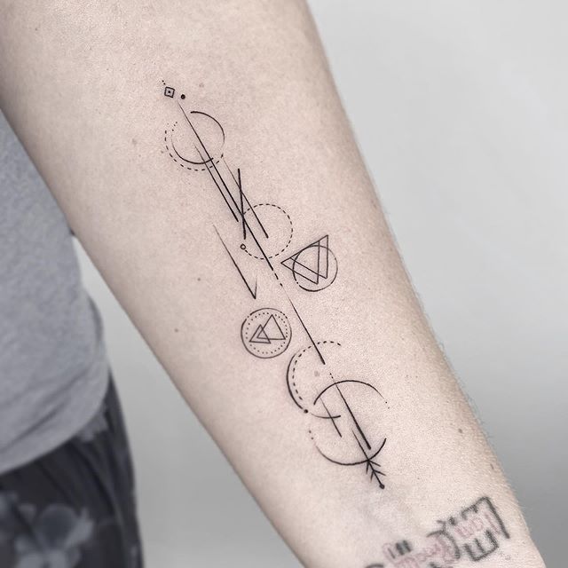 Geometric tattoo of circles, lines and triangles on the left hand