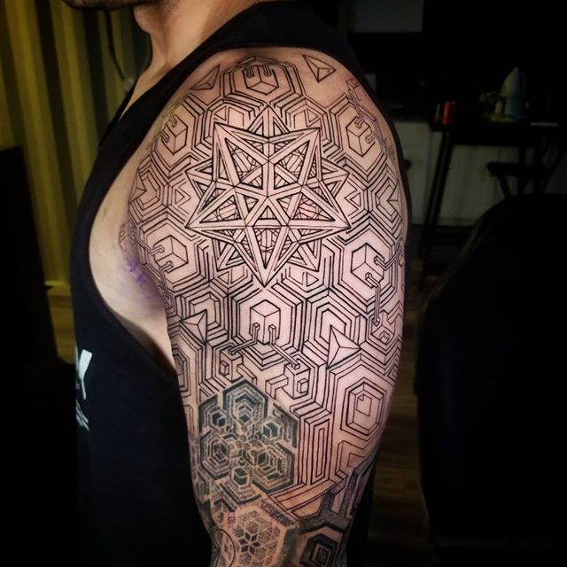 Geometric tattoo of lines, squares and triangles on the left hand