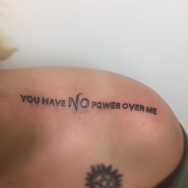 Lettering tattoo of a "you have no power over me"