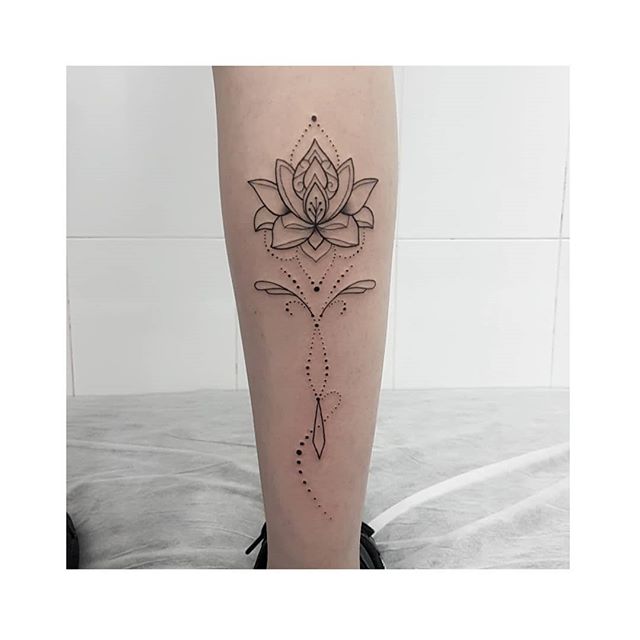 Mandala tattoo of a lotus flower on the right calf