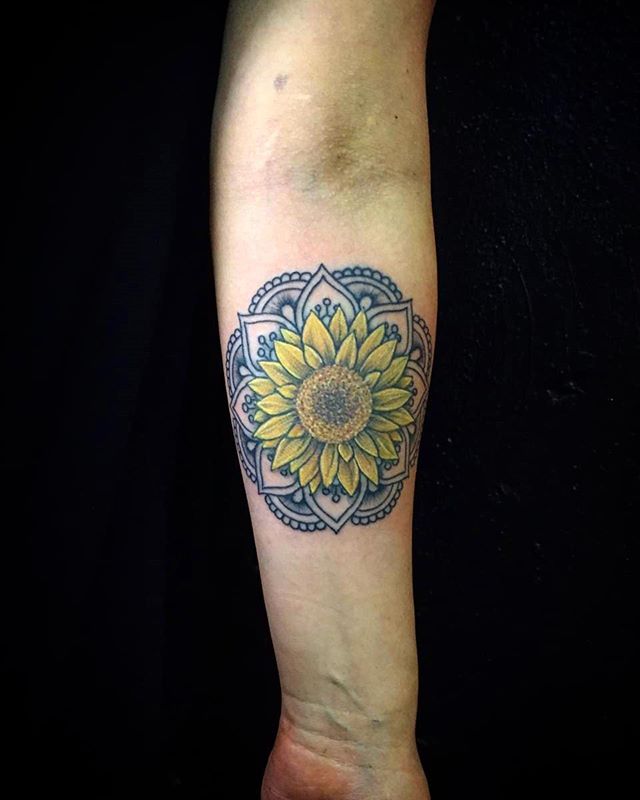 Mandala tattoo of a sunflower on the left hand
