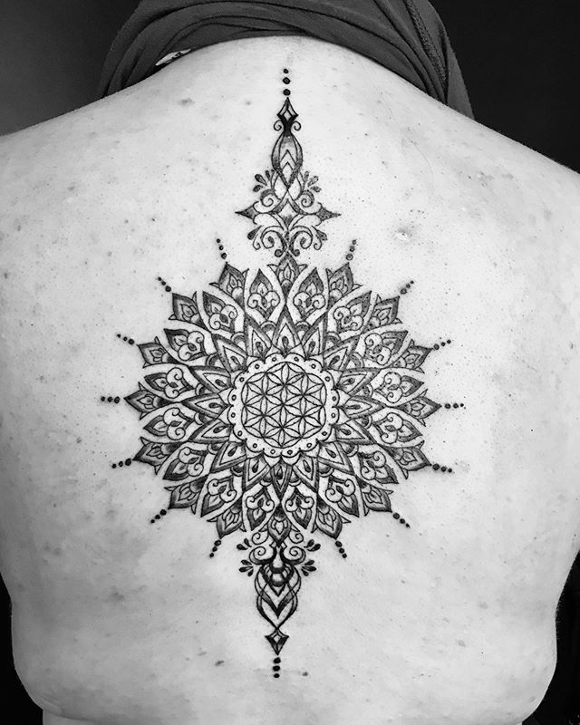 Mandala tattoo of a flower on the back