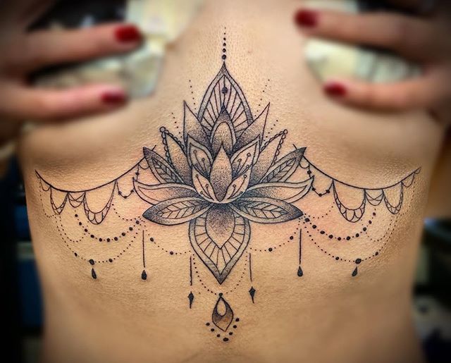Mandala tattoo of a lotus flower on the back