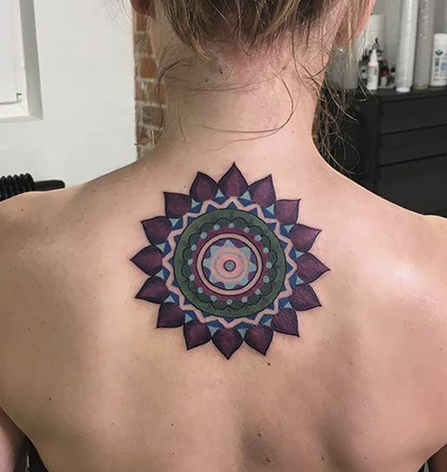 Mandala tattoo of a flower on the back