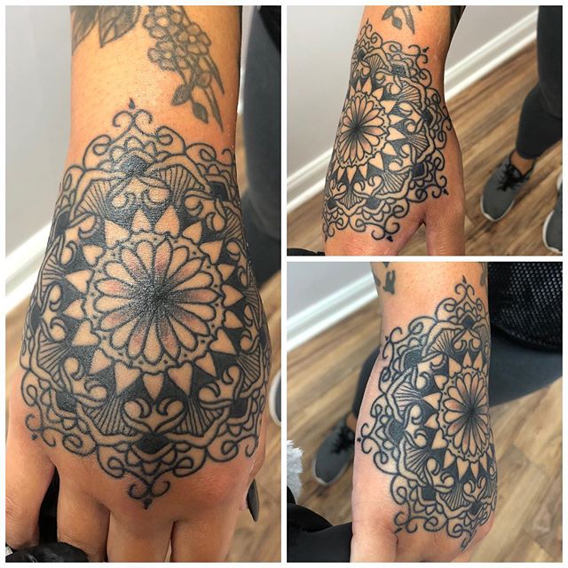 Mandala tattoo of a flower on the right hand