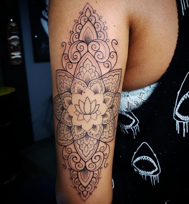 Mandala tattoo of a lotus flower on the left hand