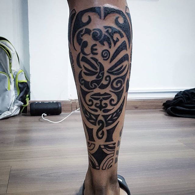 Maori tattoo of a face on the right calf