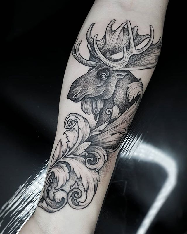 Neotraditional tattoo of a moose with leaf on the right arm