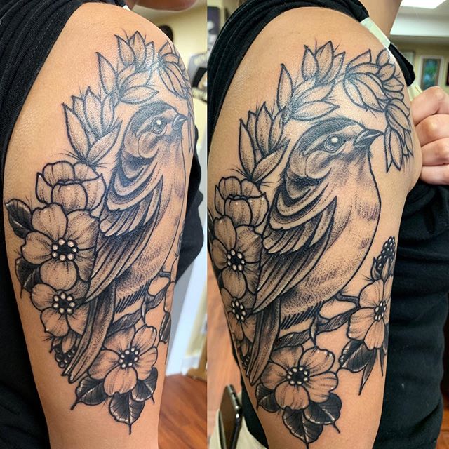 Neotraditional tattoo of a sparrow on branch with flowers on the right shoulder