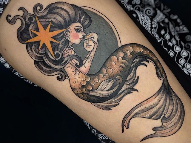 Neotraditional tattoo of a mermaid looking on the mask