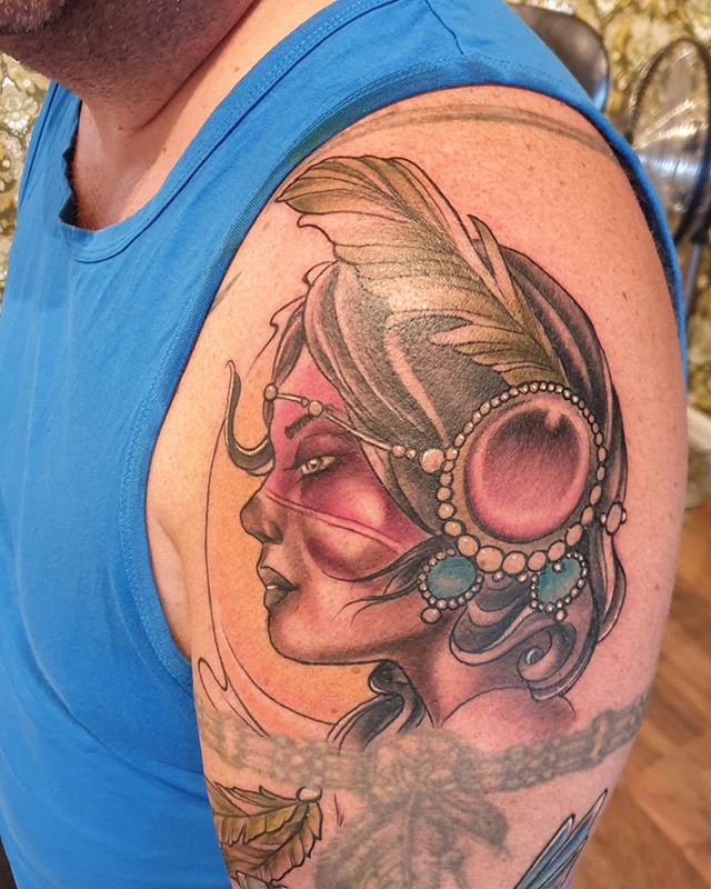 Neotraditional tattoo of a woman with feather on the left shoulder