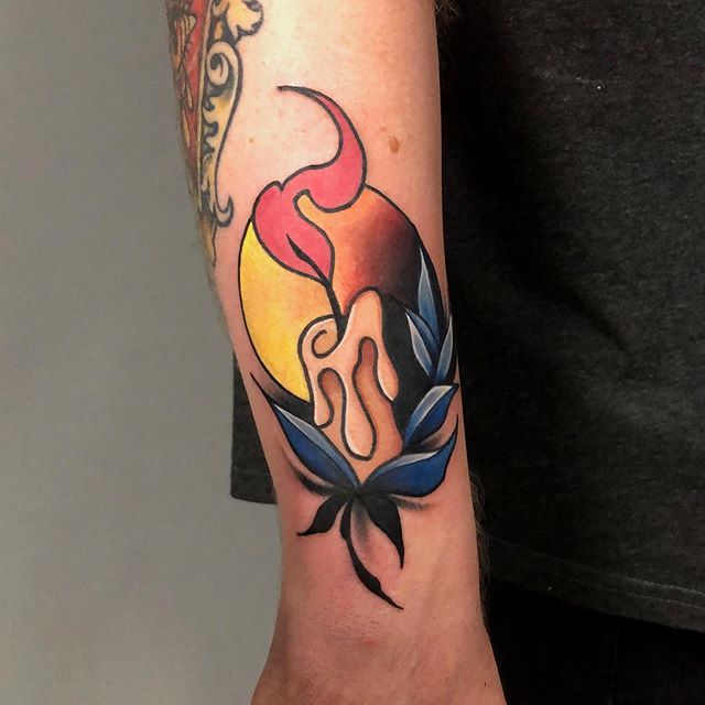 Neotraditional tattoo of a lit candle on the right arm