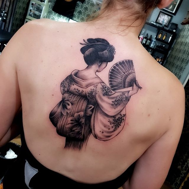 Oriental tattoo of geisha on the back