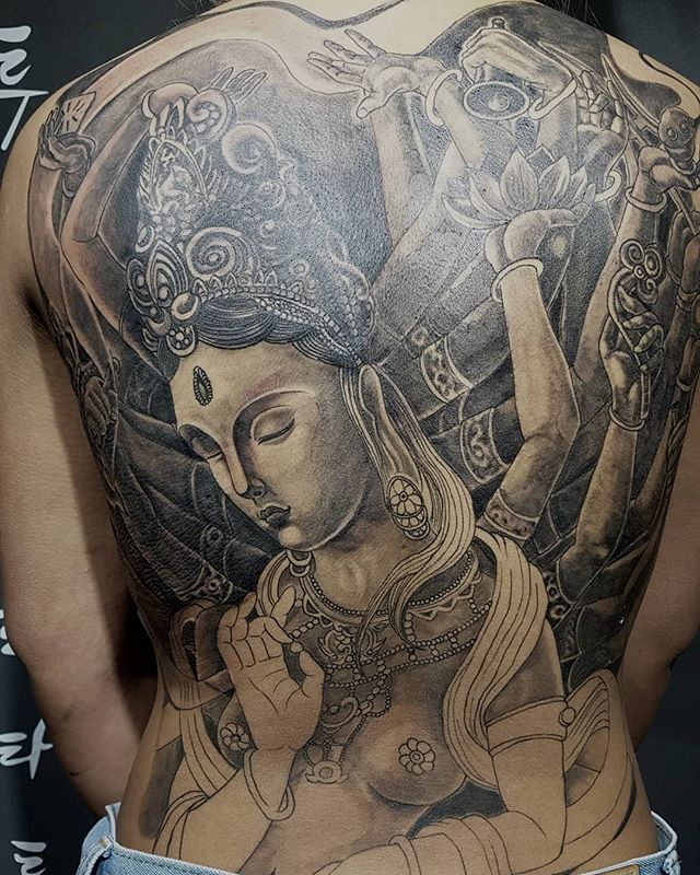 Oriental tattoo of goddess Shakti on the back