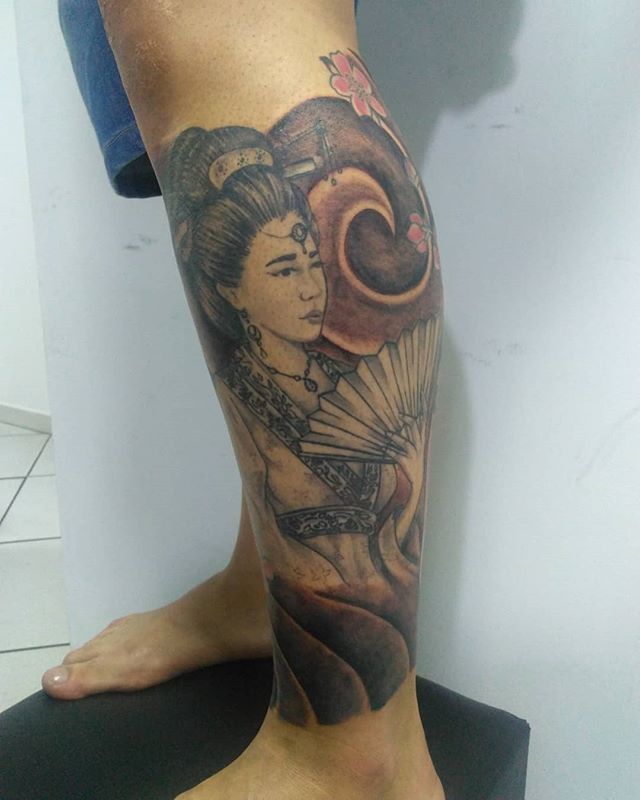 Oriental tattoo of geisha on the left calf