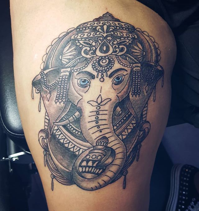Oriental tattoo of a decorated elephant on the left leg