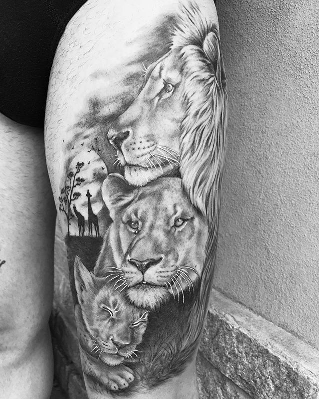 Realistic tattoo of a lion, lioness and their cub on the left leg