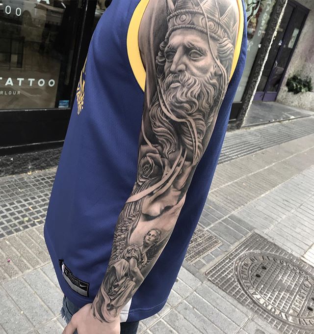 Realistic tattoo of a Greek god and a goddess on the left arm