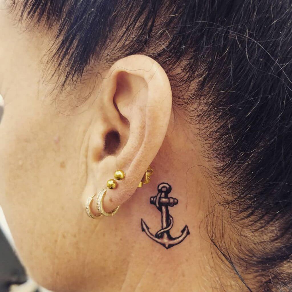 Black Anchor tattoo behind the ear