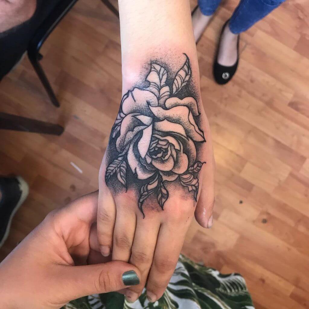 Dot work rose tattoo on the right hand