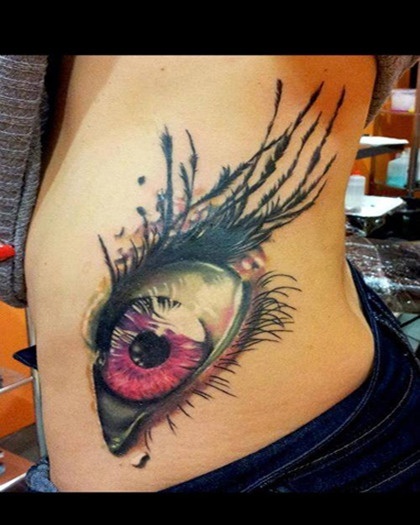 3 D tattoo of an eye on the ribs