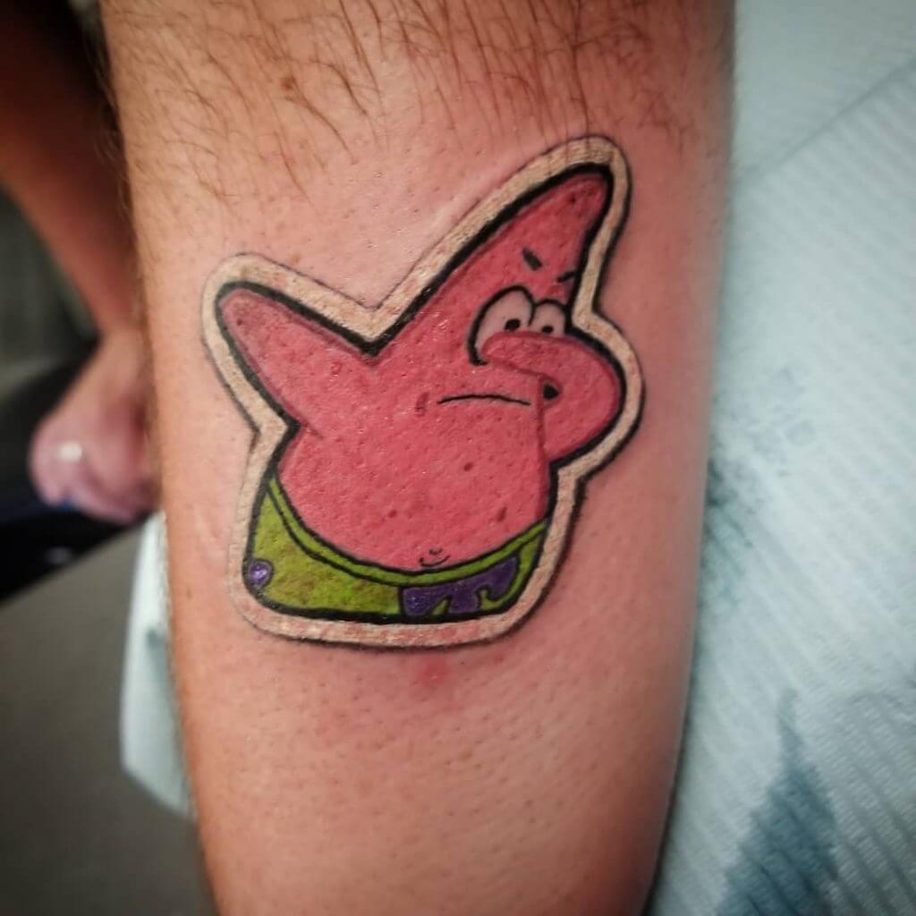 Patrick Sticker tattoo on the left forearm