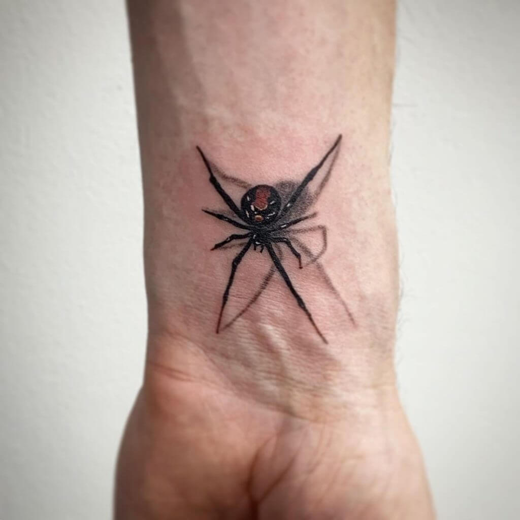 3 D tattoo of a spider on the left forearm