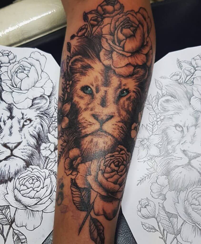 Black Forearm tattoo of a lion head with roses