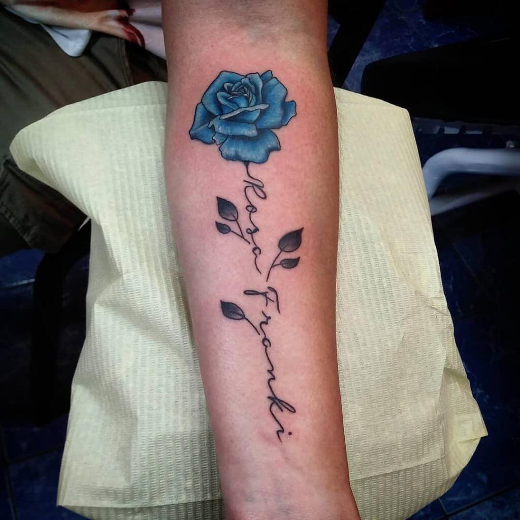 Color Rose tattoo on the left forearm