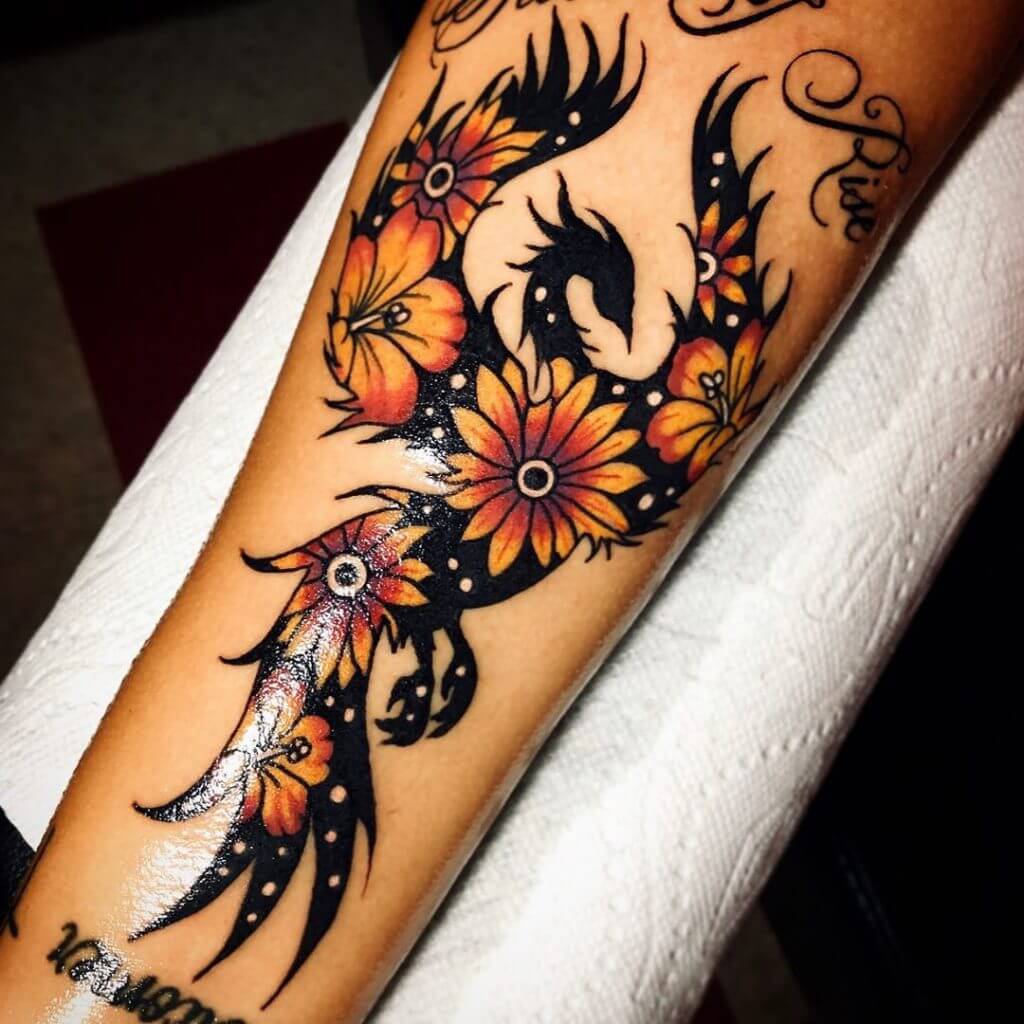 Forearm tattoo of a flowered phoenix